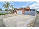 Single-story home featuring a spacious driveway and an attached garage, complimented by a well-kept lawn at 1102 Goshen Rd, Tarpon Springs, FL 34689
