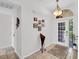 Bright foyer featuring tile flooring, a decorative light fixture, and a white front door with sidelights at 1102 Goshen Rd, Tarpon Springs, FL 34689