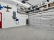 A spacious garage with epoxy flooring and ample storage, equipped with an electric car charger at 1102 Goshen Rd, Tarpon Springs, FL 34689