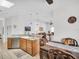Well-lit kitchen with a light granite countertop island, stainless steel appliances, and modern hanging lights at 1102 Goshen Rd, Tarpon Springs, FL 34689