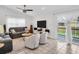 Comfortable living room with tile floors, modern furniture, and natural light coming through large windows at 1102 Goshen Rd, Tarpon Springs, FL 34689