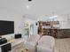 Open-concept living room showcasing tile floors, a breakfast bar, and views of the patio at 1102 Goshen Rd, Tarpon Springs, FL 34689