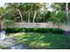Welcoming entrance to A.L. Anderson Park with a stone sign, lawn, and vibrant landscaping at 1102 Goshen Rd, Tarpon Springs, FL 34689