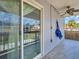 A covered patio with ceiling fan, tile floors and sliding glass doors at 1102 Goshen Rd, Tarpon Springs, FL 34689