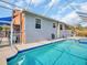 Beautiful pool with a screened enclosure and deck chairs at 1102 Goshen Rd, Tarpon Springs, FL 34689