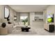 An open-concept living room features a sofa, dining space, and kitchen at 11084 E 65Th Ter, Palmetto, FL 34221