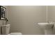 Practical powder room with pedestal sink, toilet, and modern decor, offering convenience and style at 11084 E 65Th Ter, Palmetto, FL 34221