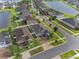 Aerial view of a neighborhood showcasing well-maintained homes, lush landscaping, and nearby lakes at 11714 Sunburst Marble Rd, Riverview, FL 33579