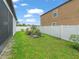 Backyard featuring a well-maintained lawn and white fence at 11714 Sunburst Marble Rd, Riverview, FL 33579