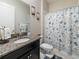 Granite-topped vanity and shower with nautical-themed curtain in bathroom at 11714 Sunburst Marble Rd, Riverview, FL 33579