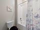 Cozy bathroom showcases a bathtub with shower, toilet, and a decorative shower curtain with butterfly pattern at 11714 Sunburst Marble Rd, Riverview, FL 33579