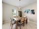 Dining room features a chandelier, neutral walls, and a window offering natural light at 11714 Sunburst Marble Rd, Riverview, FL 33579