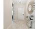 Bright entryway features a modern mirror, tiled floors, and stylish light fixture at 11714 Sunburst Marble Rd, Riverview, FL 33579