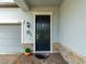 Inviting front entry featuring a stylish black door with decorative stone accents and brick pavers at 11714 Sunburst Marble Rd, Riverview, FL 33579
