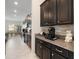 Kitchen area featuring dark wood cabinetry, granite countertops, and stainless steel appliances at 11714 Sunburst Marble Rd, Riverview, FL 33579