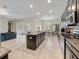 Open concept kitchen with an island, stainless steel appliances, and view to the living room at 11714 Sunburst Marble Rd, Riverview, FL 33579