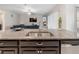 Close up of a large sink, granite counters, and stainless steel appliances at 11714 Sunburst Marble Rd, Riverview, FL 33579