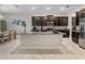 Modern kitchen with an island, granite countertops, and dark cabinetry at 11714 Sunburst Marble Rd, Riverview, FL 33579