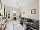 Cozy living room with plush gray seating, ceiling fan, and built-in display cabinets at 11714 Sunburst Marble Rd, Riverview, FL 33579