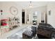 Inviting living room with comfortable gray seating, tile flooring, and display cabinets at 11714 Sunburst Marble Rd, Riverview, FL 33579
