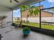Enclosed patio area with green plants and view to the backyard at 11714 Sunburst Marble Rd, Riverview, FL 33579