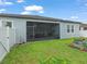 Screened patio in backyard with green lawn at 11714 Sunburst Marble Rd, Riverview, FL 33579