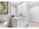 Bright bathroom featuring tiled floors, a toilet, sink and mirror with storage at 1325 Snell Isle Ne Blvd # 708, St Petersburg, FL 33704