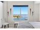Beautiful water view from the bedroom window, complemented by elegant wall sconces and a cozy seating area at 1325 Snell Isle Ne Blvd # 708, St Petersburg, FL 33704
