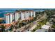 Upscale waterfront condominium building featuring a white facade, tile roof, and lush landscaping at 1325 Snell Isle Ne Blvd # 708, St Petersburg, FL 33704