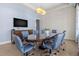 Dining room with modern lighting, textured walls, and a large TV for sophisticated entertaining at 1325 Snell Isle Ne Blvd # 708, St Petersburg, FL 33704