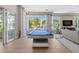 Bright game room with a pool table, large windows with tropical views, and comfortable seating area at 1325 Snell Isle Ne Blvd # 708, St Petersburg, FL 33704
