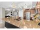 Spacious kitchen island with stone counters, stainless steel refrigerator, and a view into the living space at 1325 Snell Isle Ne Blvd # 708, St Petersburg, FL 33704