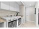 Functional laundry room equipped with modern washer, dryer, storage cabinets, and granite countertops at 1325 Snell Isle Ne Blvd # 708, St Petersburg, FL 33704