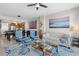 Comfortable living room featuring a plush white sofa, stylish armchairs, and a vibrant blue patterned rug at 1325 Snell Isle Ne Blvd # 708, St Petersburg, FL 33704