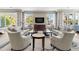 A lounge area with comfortable seating, a television, and large windows offering plenty of natural light at 1325 Snell Isle Ne Blvd # 708, St Petersburg, FL 33704