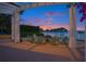 Scenic waterfront patio with a fire pit at dusk, ideal for outdoor entertaining and enjoying beautiful sunsets at 1325 Snell Isle Ne Blvd # 708, St Petersburg, FL 33704