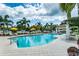 Resort-style pool with lounge chairs and umbrellas, set amidst lush tropical landscaping and a view of the marina at 1325 Snell Isle Ne Blvd # 708, St Petersburg, FL 33704