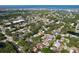 Aerial view of the neighborhood with a mix of residential properties, lush greenery, and proximity to the ocean at 13725 Oak Forest N Blvd, Seminole, FL 33776