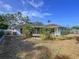 A quaint backyard features a rounded landscape area, a screened patio, and direct access to the home at 13725 Oak Forest N Blvd, Seminole, FL 33776