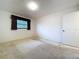 Standard bedroom with small window, carpet flooring, and neutral colored walls at 13725 Oak Forest N Blvd, Seminole, FL 33776