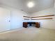 Standard bedroom with desk and shelving, carpet flooring, and neutral colored walls at 13725 Oak Forest N Blvd, Seminole, FL 33776