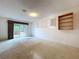Large bedroom with sliding glass door to the outdoors at 13725 Oak Forest N Blvd, Seminole, FL 33776