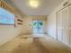 Bright bedroom with carpet flooring, sliding glass doors, window, and closet at 13725 Oak Forest N Blvd, Seminole, FL 33776