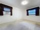 Bedroom with carpet flooring, window and an air conditioner at 13725 Oak Forest N Blvd, Seminole, FL 33776