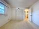 Standard bedroom with closet, carpet flooring, and neutral colored walls at 13725 Oak Forest N Blvd, Seminole, FL 33776