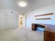 Standard bedroom with desk and closet, carpet flooring, and neutral colored walls at 13725 Oak Forest N Blvd, Seminole, FL 33776
