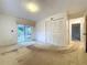 Bright bedroom with carpet flooring, sliding glass doors, and a closet at 13725 Oak Forest N Blvd, Seminole, FL 33776