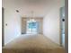 This dining room features a chandelier, sliding glass doors to the backyard, and lots of natural light at 13725 Oak Forest N Blvd, Seminole, FL 33776