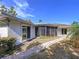 Back of home and exterior walkway with view of the screened porch at 13725 Oak Forest N Blvd, Seminole, FL 33776