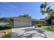 A beautiful single-story home with a brick-paved driveway leading to a two-car garage at 13725 Oak Forest N Blvd, Seminole, FL 33776